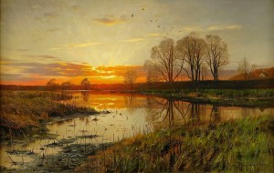 Landscape with sun going down over a lake